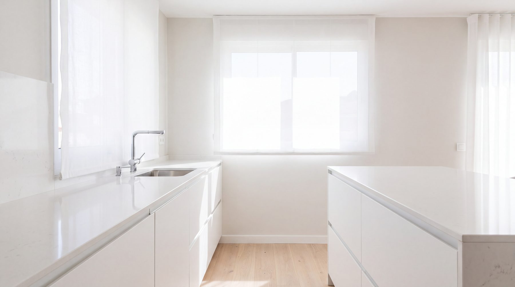 Empty kitchen after a clean, gleaming counters, sun through a sheer blind