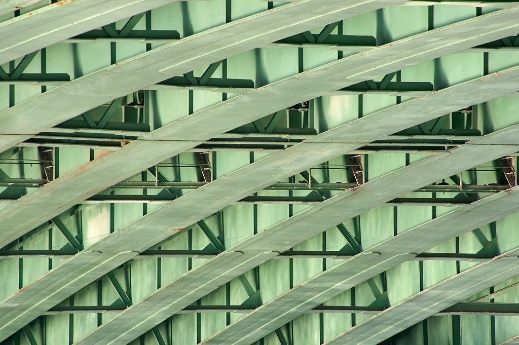 Rows of riveted steel bridge structure, seen close
